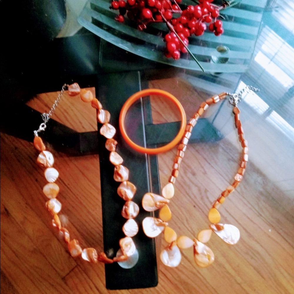2 woman’s necklaces with bracelet